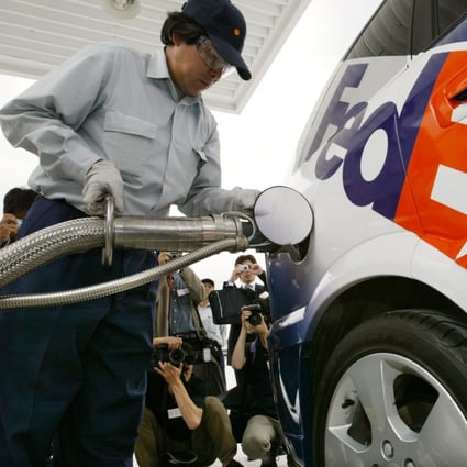 The “HydroGen 3" fuel-cell vehicle being refuelled with hydrogen in Tokyo on July 9, 2003, the first such vehicle in Japan to receive a “green” commercial number plate. FedEx will use the vehicle on its regular delivery routes in a one-year collaboration with General Motors. Photo: Reuters