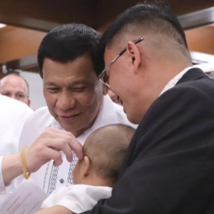Senator Lawrence “Bong” Go, President Rodrigo Duterte, and Bureau of Corrections chief Nicanor Faeldon at the baptism of Faeldon’s son. Photo: Handout