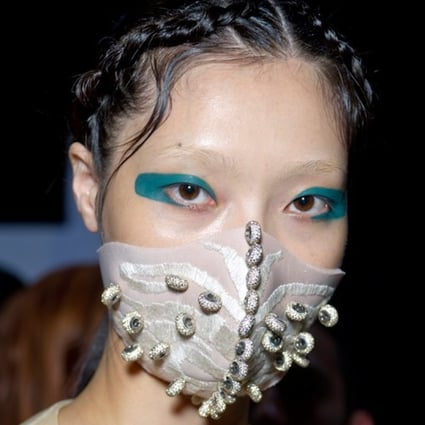Chinese designer Masha Ma has joined models, musicians and social media influencers in launching versions of the face mask. She embedded her SS15 collection with Swarovski crystals and presented them at Paris Fashion Week.