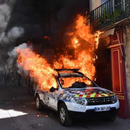 A police car burns on the sidelines of a yellow vest demonstration in Montpellier on Saturday. Photo: AFP