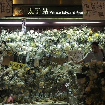 Flowers and other symbols of mourning have been placed on the gates of an exit of Prince Edward MTR station. Photo: Sam Tsang