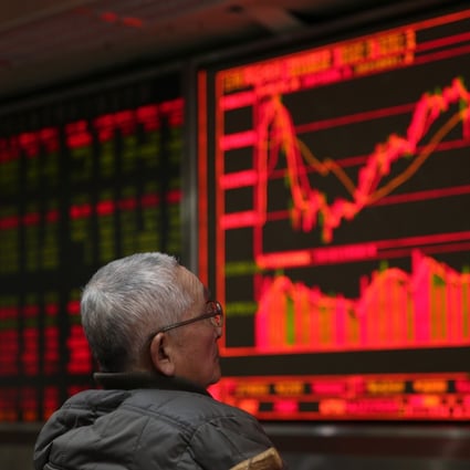 A Chinese investor before an electronic display of stock data at a brokerage house in Beijing on 15 February 2016. Contrary to global conventions, China represents gains and advances in red, using the colour green to denote losses and declines. Photo: EPA