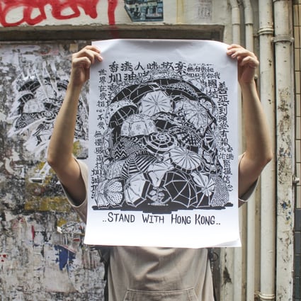 Graffiti artist Boms with his protest poster in a street in Mong Kok. Photo: Snow Xia