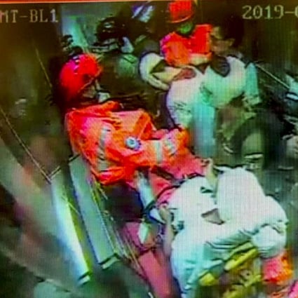 A screengrab of security footage shows paramedics escorting three of the injured out of Yau Ma Tei station. Photo: Handout
