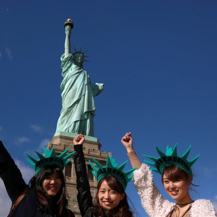 Japanese tourists at the Statue of Liberty, in New York City, in the United States. Photo: Reuters