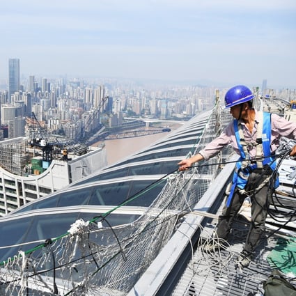 Workers brave the summer heat to build a skyscraper in Chongqing last month. Photo: Xinhua