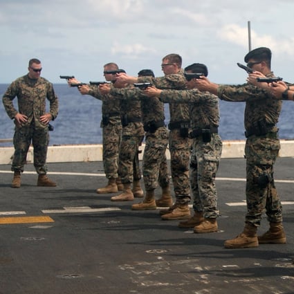US Marines practise speed reloads on August 9 aboard the USS Green Bay, part of the Wasp Amphibious Ready Group, in the Indo-Pacific region. Photo: Handout