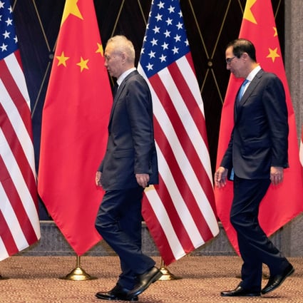 U.S. Trade Representative Robert Lighthizer points at markers on the floor as he leads Chinese Vice Premier Liu He and Treasury Secretary Steven Mnuchin to their position for a family photo at the Xijiao Conference Center in Shanghai, China, July 31, 2019. Ng Han Guan/Pool via REUTERS