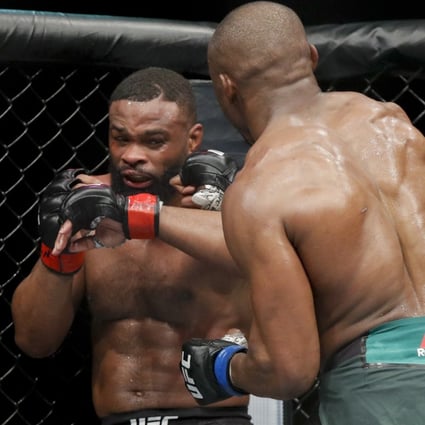 Kamaru Usman (right) hits Tyron Woodley at UFC 235. Photo: AP