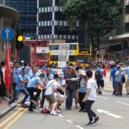 A group of government supporters clash with local residents outside Fortress Hill MTR station on Saturday. Photo: Facebook