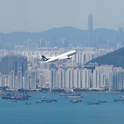 A flight takes off with Hong Kong in the background. Photo: Reuters