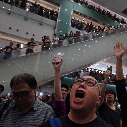 Local residents sing Glory to Hong Kong at a shopping mall on September 11. Protesters have found a sense of community in gathering to call for reform and to defend their way of life. Photo: AP