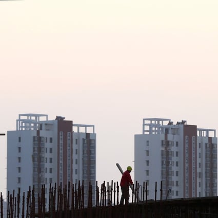 A worker stands on the scaffolding at a construction site in Huaian, Jiangsu province, China. Photo: Reuters