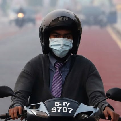 A man rides on a motorcycle in the haze in Putrajaya, Malaysia. Photo: Reuters