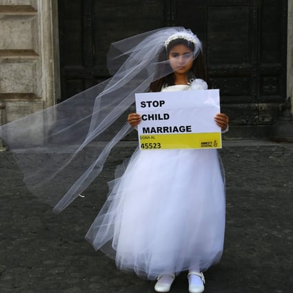 A 10-year-old actress dons a wedding gown at an event organised by Amnesty International to denounce child marriage. Photo: AFP