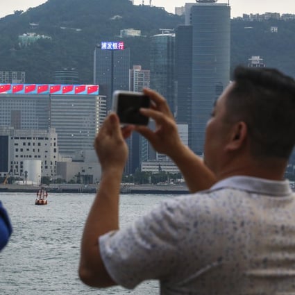 Tourists at Victoria Harbour in Hong Kong’s Tsim Sha Tsui. Photo: Felix Wong