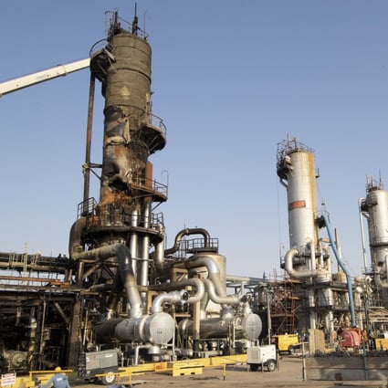 Workers repair a refining tower at Saudi Aramco’s Abqaiq crude oil processing plant following a drone attack. Photo: Bloomberg