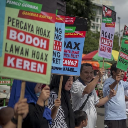 Residents of Jakarta carry placards during an anti-hoax campaign. Photo: Handout