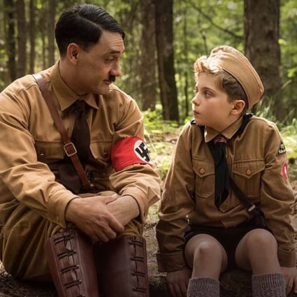 Taika Waititi and Roman Griffin Davis in a scene from Jojo Rabbit (category: TBC), directed by Waititi. The film also stars Sam Rockwell and Scarlett Johansson.