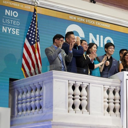 NIO's first employee Li Tianshu (centre) and members of the company's leadership team ring the opening bell of the New York Stock Exchange before the company’s initial public offering on 12 September 2018. Photo: EPA-EFE