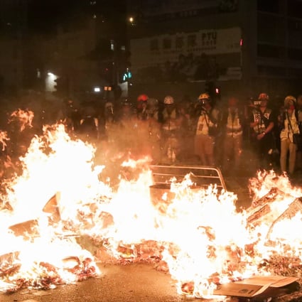 Anti-government protesters start a fire on Nathan Road near Mong Kok Police Station on September 22. Photo: Edmond So