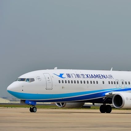 === PHOTO CAPTURED FROM WEIBO === A flight was delayed for an hour and a woman detained by police after she opened the emergency exit for Òa breath of fresh airÓ before the flight took off in central Hubei province on Monday. The incident happened on flight Xiamen Air MF8215, which was scheduled to take off in Wuhan at 15:45 after passengers boarded the plane for Lanzhou, Gansu province on the afternoon, reported the Btime Video. Air stewardess had briefed the woman, who looked to be in her 50s, about the rules of sitting next to the emergency exit and reminded her not to touch the button that could open the emergency exit. WEIBO