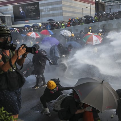 Riot police fire water cannon at demonstrators in Hong Kong earlier this month. Anti-government protests have gripped the city since early June. Photo: Sam Tsang