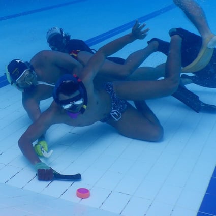 Indonesia’s men’s underwater hockey team practice during a training session at the Senayan Aquatic Centre in Jakarta ahead of the Southeast Asian (SEA) Games. Photo: AFP