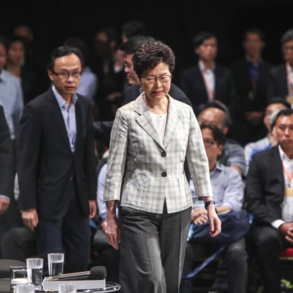 Chief Executive Carrie Lam (centre) arrives to meet the public during a dialogue session at Queen Elizabeth Stadium. Photo: Winson Wong