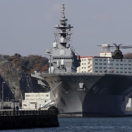 A Japanese helicopter prepares to land on the flight deck of the Izumo. Photo: AP