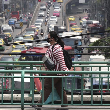 A pedestrian wears a face mask to filter dirty air in Bangkok on Monday. Photo: AP