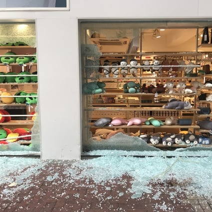 Shards of glass cover the pavement after radical elements of the protest movement target the Miniso branch in Tsuen Wan. Photo: Yujing Liu