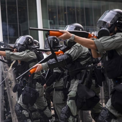 Riot police fire non-lethal rounds to disperse protesters in the Admiralty district of Hong Kong on Sunday. The violence escalated on Tuesday when an officer shot a protester at close range in the chest with a live round. Photo: Bloomberg