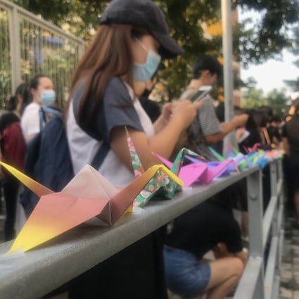 Pupils and alumni holding a sit-in near Tsuen Wan Public Ho Chuen Yiu Memorial College, chanting slogans and folding origami cranes. Photo: Kimmy Chung