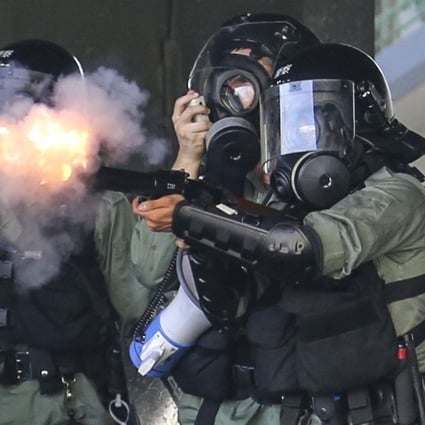 Riot police fire tear gas in Wong Tai Sin amid mass protests on National Day. Photo: James Wendlinger