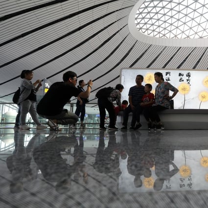 Beijing’s Daxing International Airport is a hit with travellers, but it also attracts social media snappers who get in the way of everyday business, security staff say. Photo: Simon Song