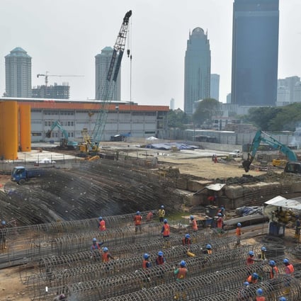 Indonesian labourers work at a construction site in Jakarta. The country has missed a wave of manufacturers seeking to bypass higher tariffs from the US-China trade war, according to two private sector economists. Photo: AFP
