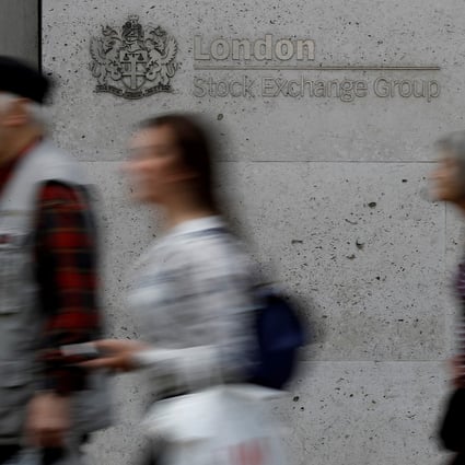 People walk past the entrance of the London Stock Exchange. Photo: Reuters