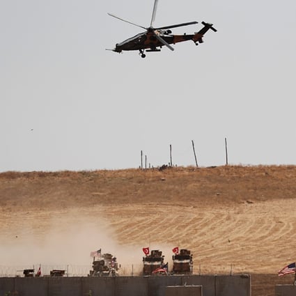 A Turkish military helicopter flies over as Turkish and US troops return from a joint US-Turkey patrol in northern Syria in September. Photo: Reuters