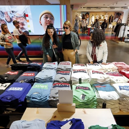 Shoppers at a Levi’s store in New York’s Times Square look at a T-shirt display in June. The domestic consumer is critical to the health of America’s economy, as consumer spending accounts for roughly 70 per cent of US economic activity. Photo: AP