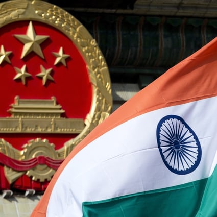 An Indian national flag is flown next to the Chinese national emblem. Photo: AP