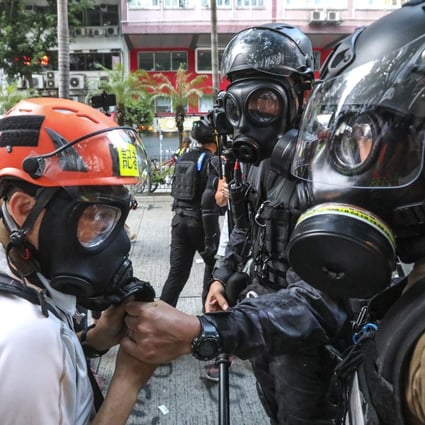 Reporters can have their gas masks removed by police under the new law. Photo: Felix Wong