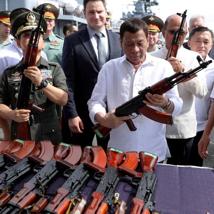 Philippine President Rodrigo Duterte holds an AK-47 assault rifle on board the Russian destroyer Admiral Panteleyev in 2017. Photo: Reuters