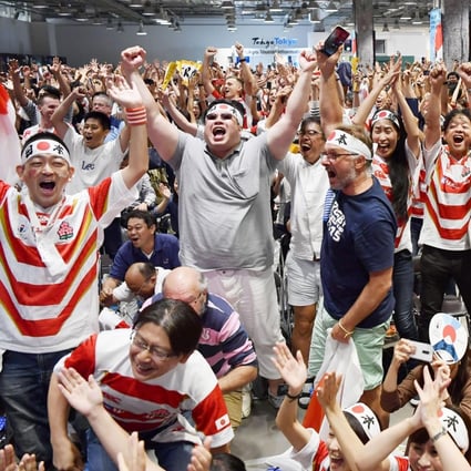 Japan fans celebrate the team’s win over Scotland at the Rugby World Cup. Photo: AP