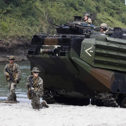 US Marines take security positions around an amphibious assault vehicle during a joint military amphibious landing exercise with Philippine and Japanese counterparts in Cavite province, Philippines. Photo: EPA-EFE
