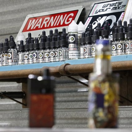Vaping machines are displayed on a counter with other items on shelves inside a shop in Texas on September 6. The US Centres for Disease Control and Prevention issued a warning on the use of e-cigarettes. Photo: EPA-EFE