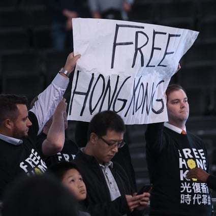 Activists hold up a sign before an NBA exhibition basketball game between the Washington Wizards and the Guangzhou Loong-Lions on October 9, 2019, in Washington. Photo: AP