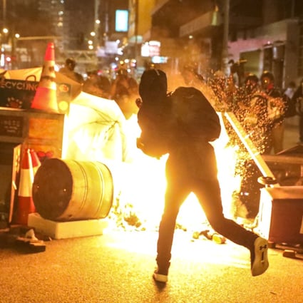 Protesters throw petrol bombs and set objects on fire during a scuffle with police on September 29. Photo: K.Y. Cheng