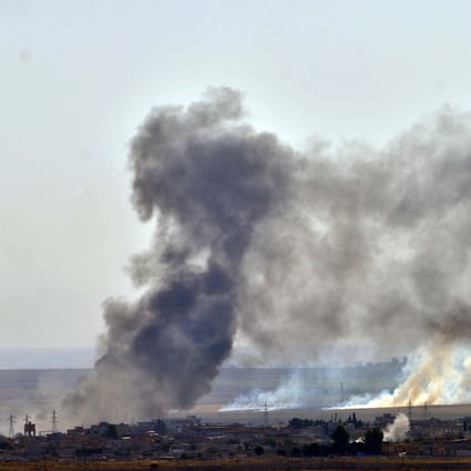 Smoke rises from the northern Syrian city of Ras al-Ain during an attack launched by the Turkish army on Sunday. Isis jihadists held captive in the area have fled. Photo: Xinhua