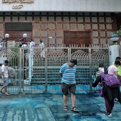 Volunteers help clean up Kowloon Mosque in Tsim Sha Tsui on Sunday after a police water cannon sprayed the building with blue-dyed water. Photo: Handout